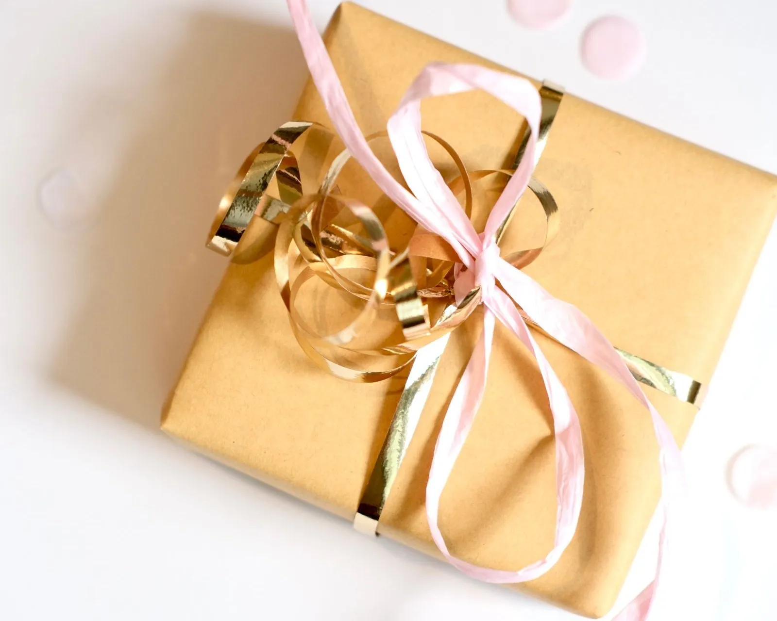 A kraft-wrapped gift tied with gold ribbon